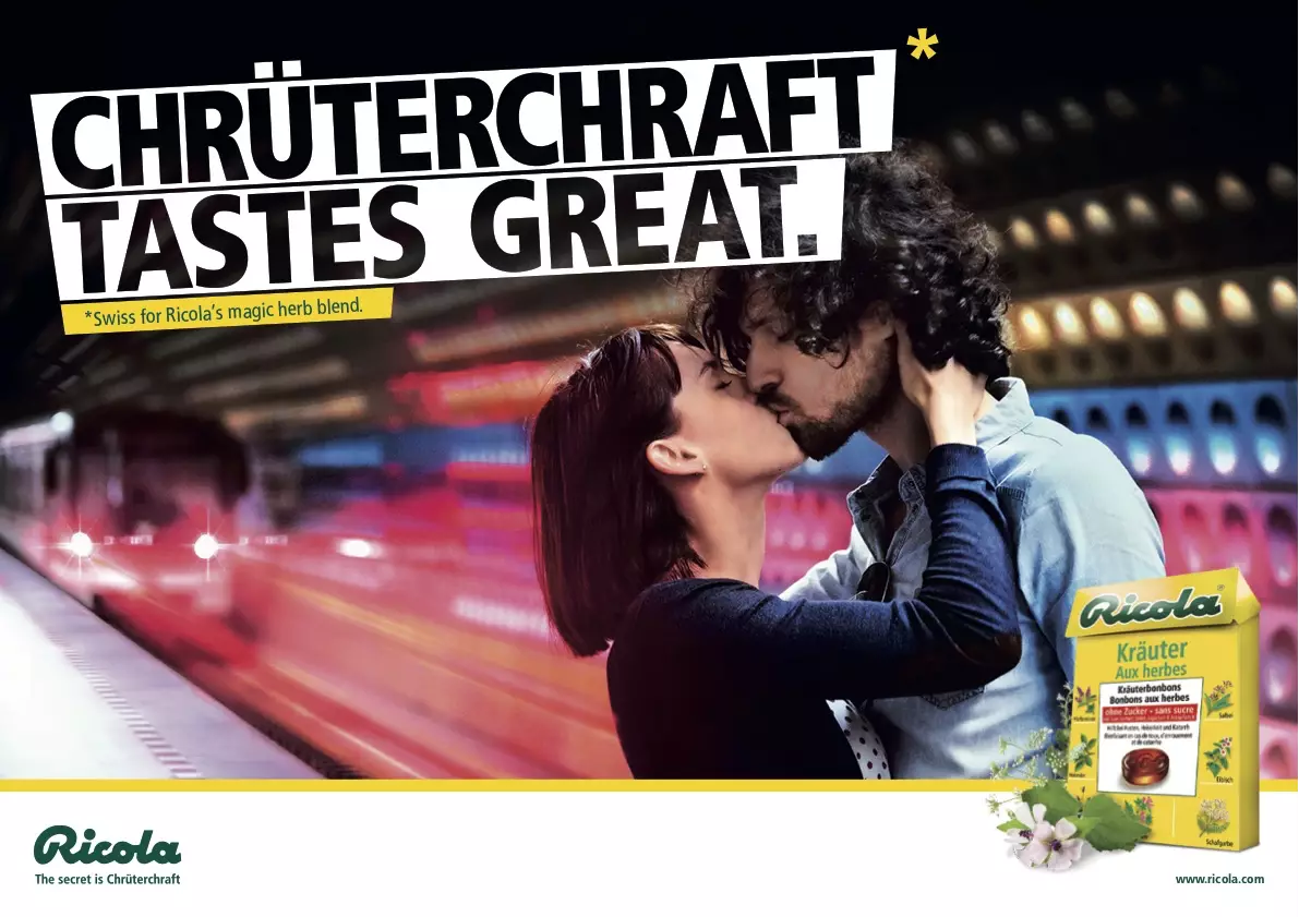 The ad shows a kissing couple in a subway train station. The headline says 
