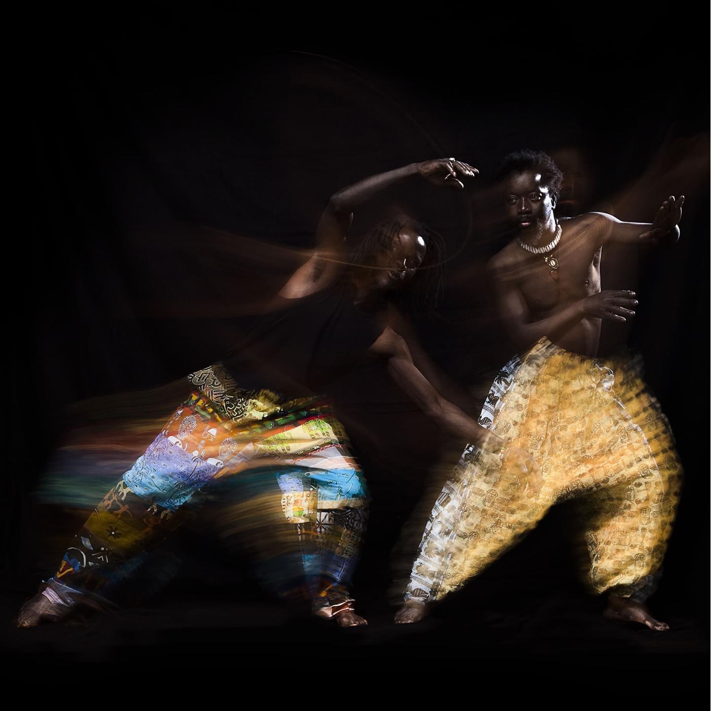 Two Senegalese dancers in frozen motion with a small amount of long exposure effect.